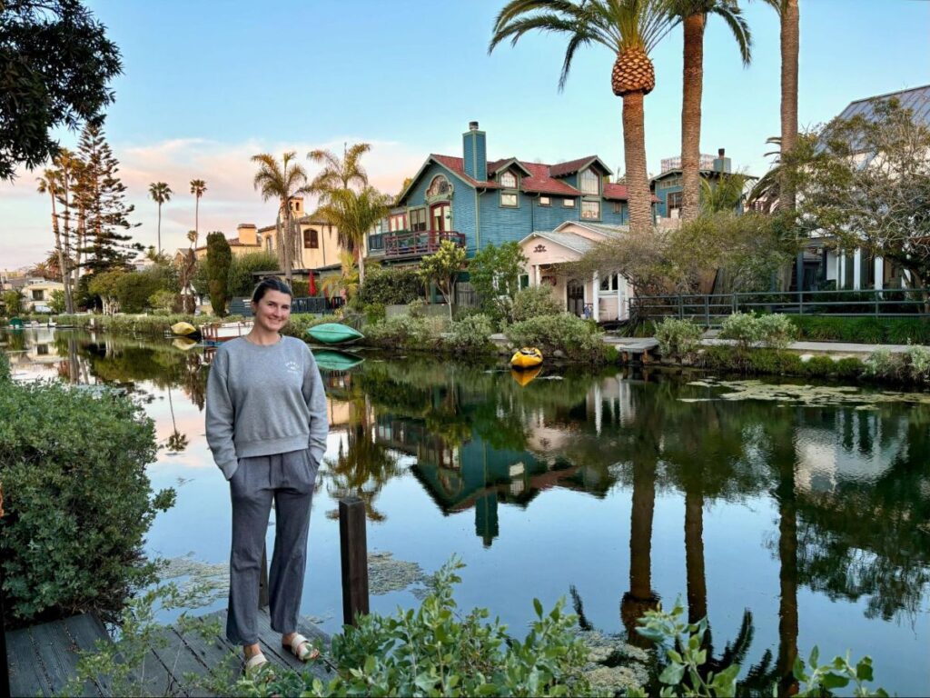 A woman standing beside the Venice Canals