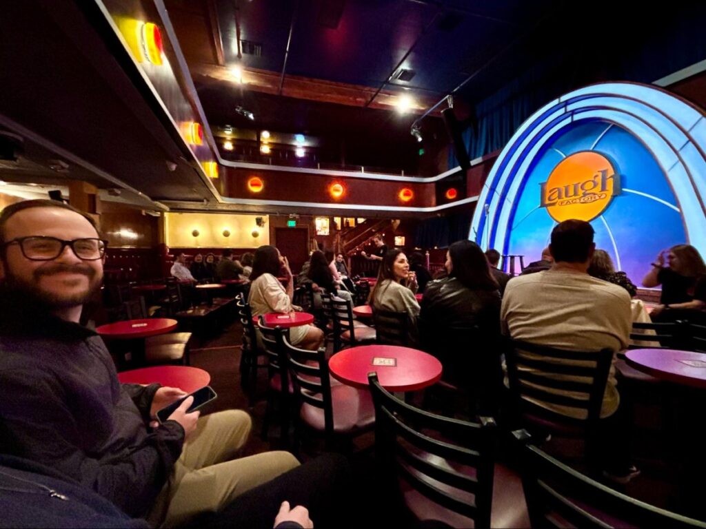 A man smiling while waiting for the performer at The Laugh Factory