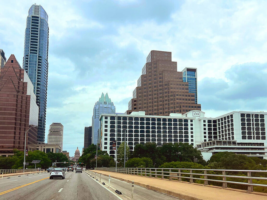 View of the LINE Hotel and the city skyline from the road
