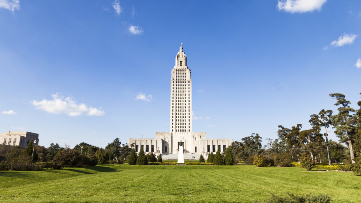 View of the Louisiana State Capitol Building surrounded by greenery in the distance