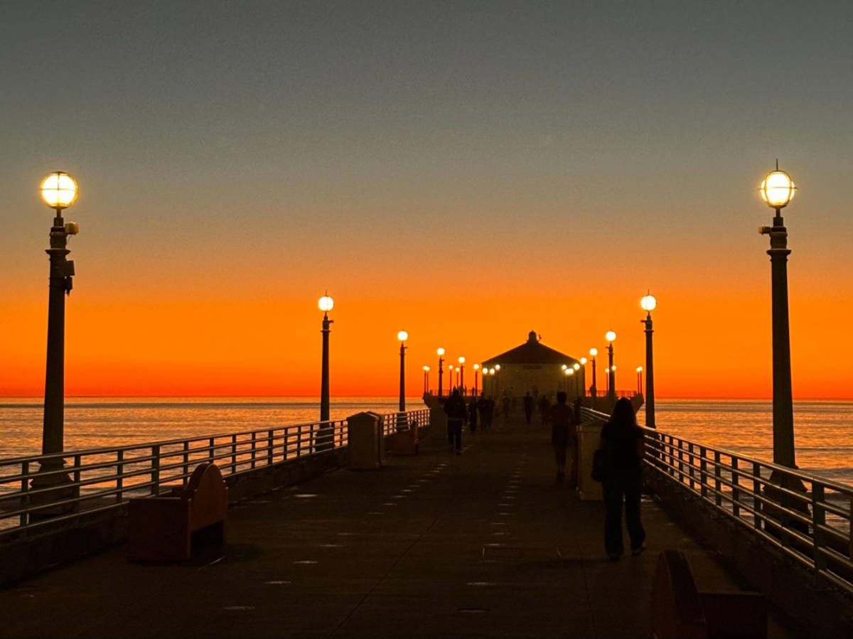 Scenic sunset view from the Manhattan Beach Pier with the lamp posts illuminated