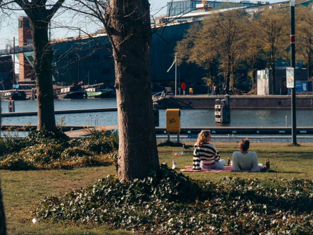 Couple having a picnic under the trees near The Marineterrein