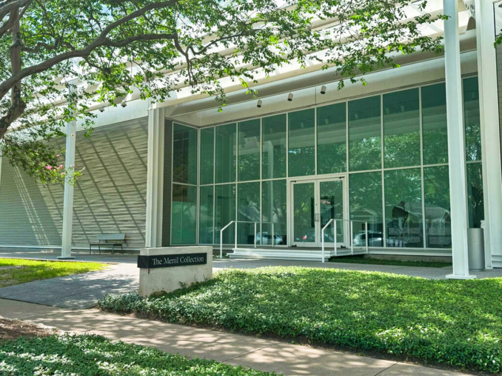 View of the glass wall and the greenery around The Menil Collection