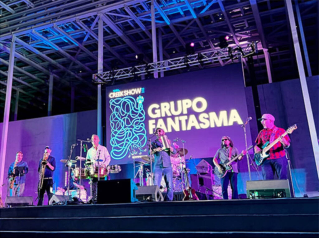 A band performing on The Moody Amphitheater