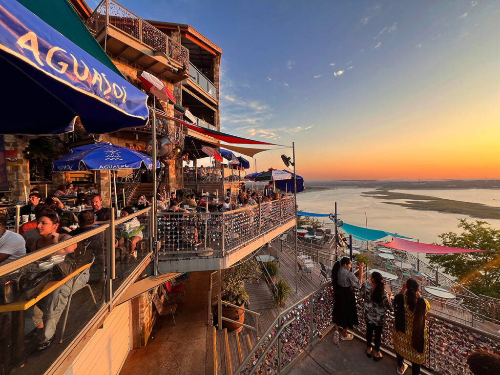 People dining and watching the sunset views at The Oasis restaurant