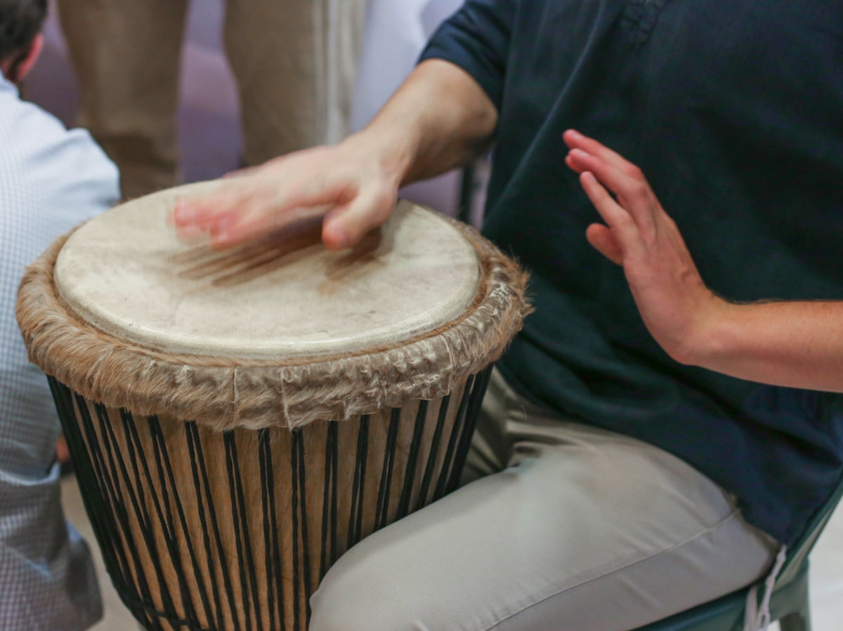Drummer play on an African djembe drum