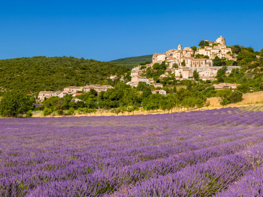 The Provence hilltop perched village of Simiane-la-Rotonde in summer with lavender fields