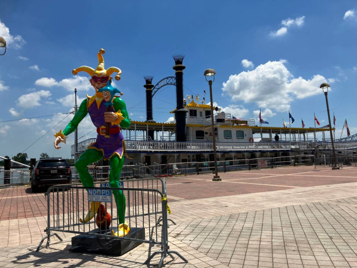 A clown statue and the The Steamboat Natchez at the dock