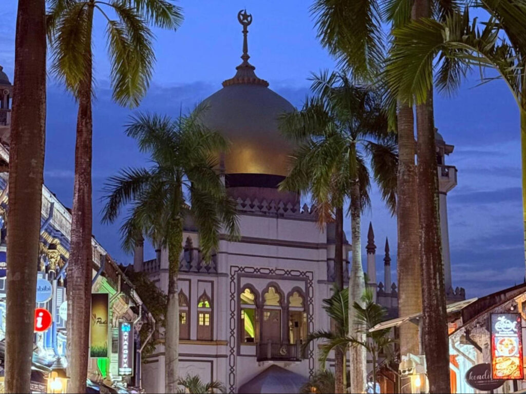 View of the Sultan Mosque surrounded by tropical trees in Kampong Glam
