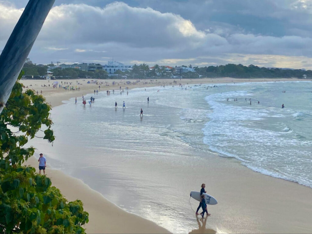 Families and surfers enjoying the beach at Sunshine Coast