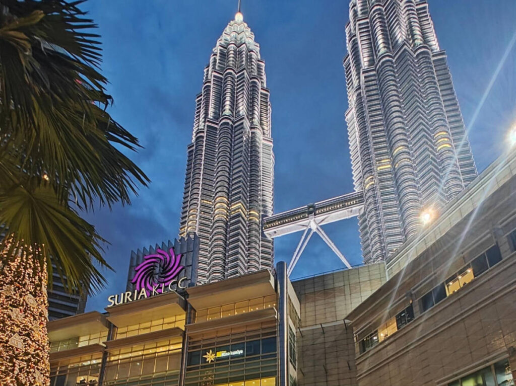 Perspective view of the Petronas Twin Towers and Suria KLCC lit at night