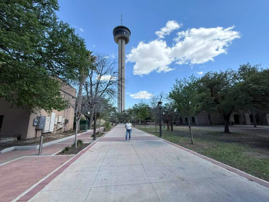 Author Jill taking a photo with The Tower of the Americas in the background