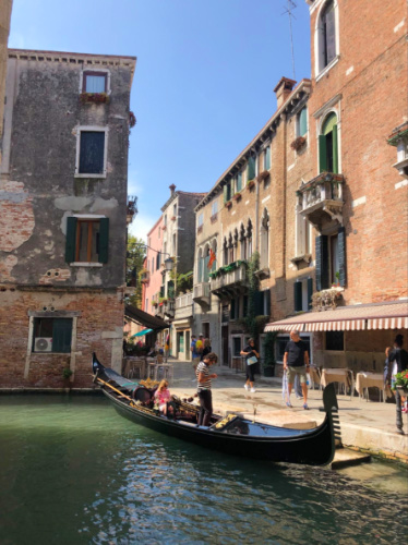 A gondola parked alongside a canal in the Venice Canals