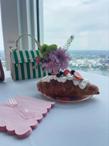 Closeup look of a plate of croissant by the window with the view of Boston