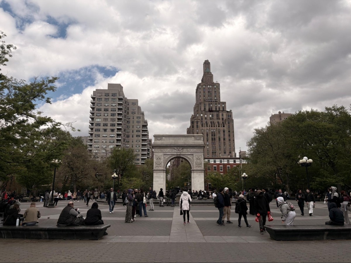 People visiting The Washington Square Park on a cloudy day