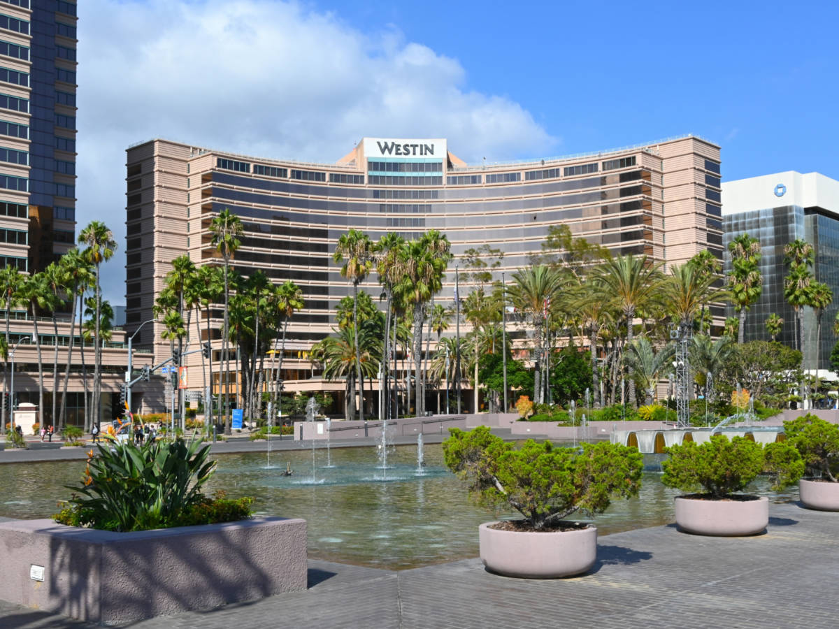 Panoramic view of unique curve exterior of The Westin Long Beach hotel with the fountain in front