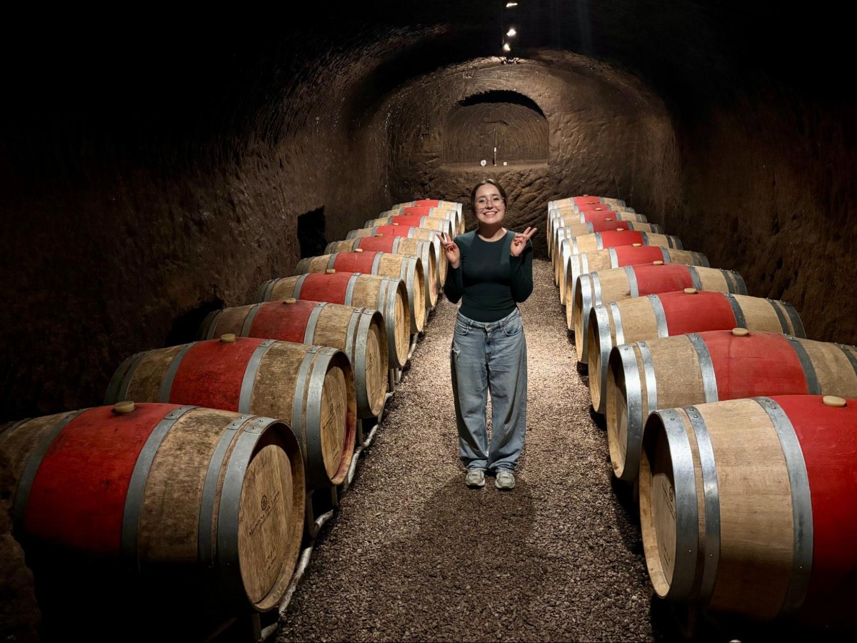 The guide Ana showing the wine barrels at a Etruscan tomb