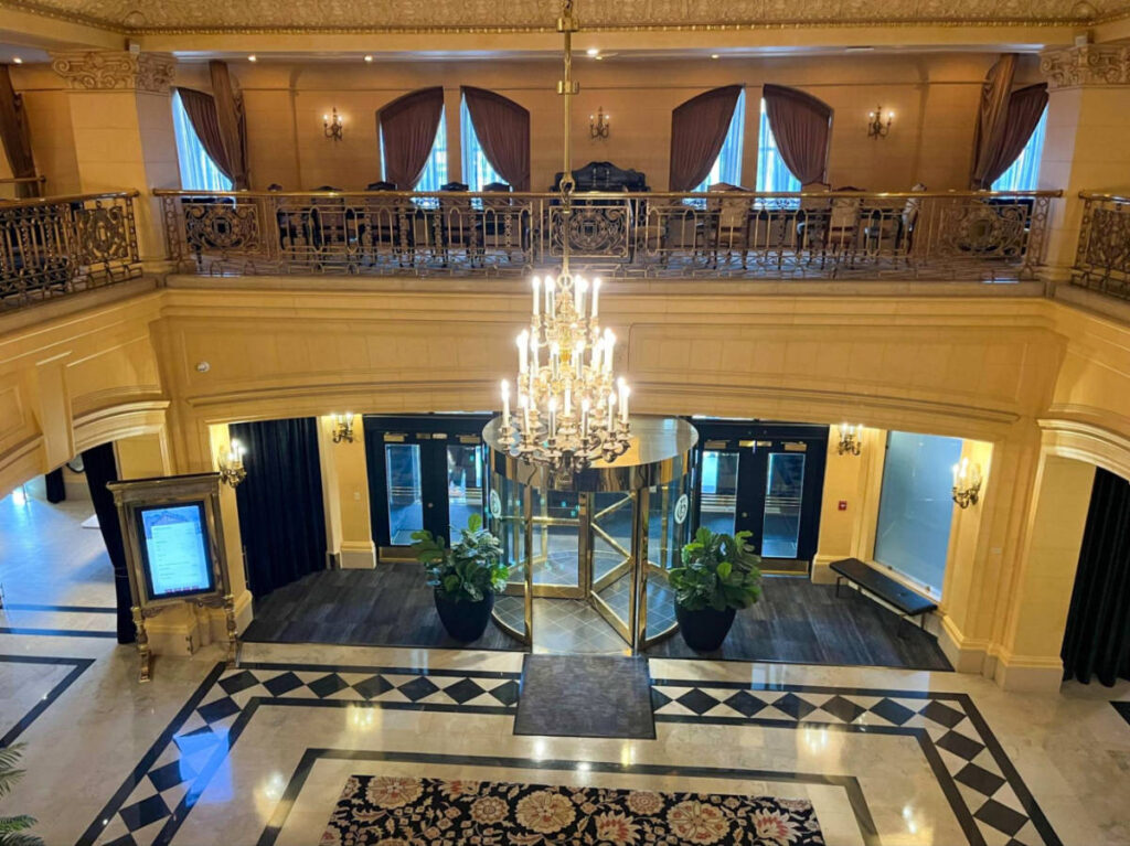 The lobby of The Fort Garry Hotel featuring an elegant chandelier