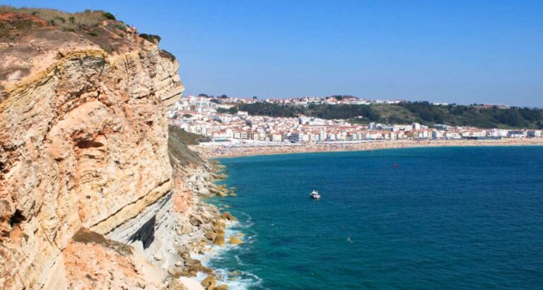 Scenic view of the ocean and the town of Nazare from a rock mountain cliff