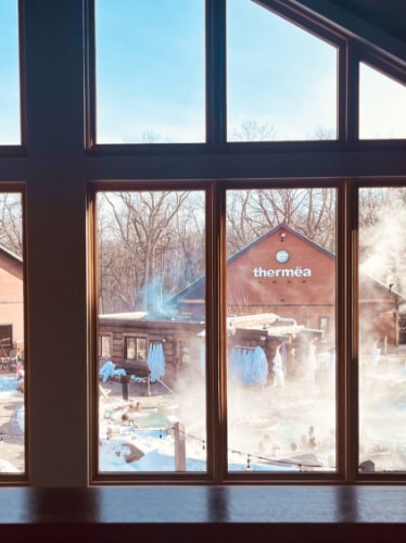 View of the smoking Thermea Spa on a winter day seen from the window