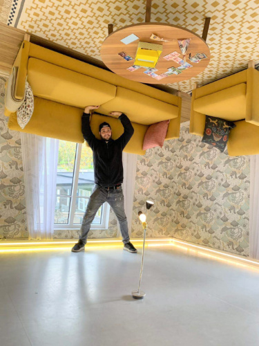 The author Thom Brown, enjoying inside the Upside-Down House in Tartu