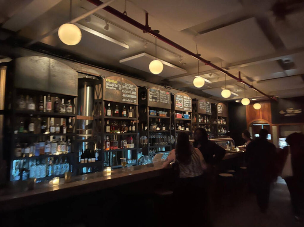 People at the bar counter in Threes Brewing