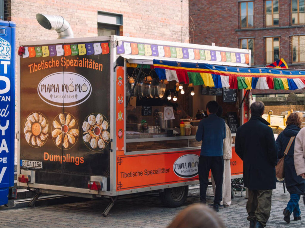 People lining in front of the Tibetan dumpling stand at the Kulturbrauerei