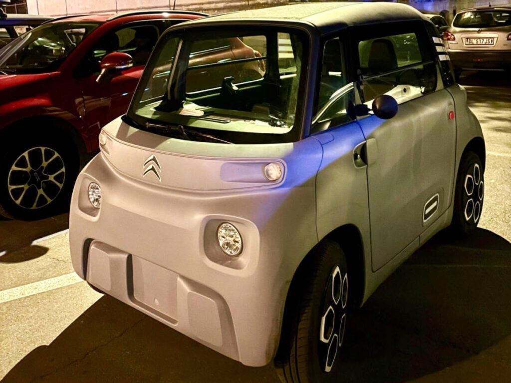 A tiny car at a parking lot in Italy