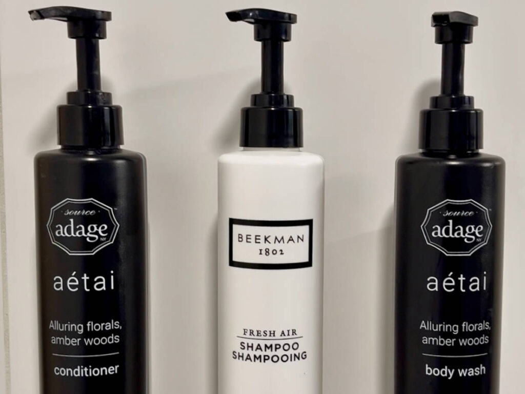 Bottles of Source Adage and Beekman on a bathroom in a room in Blue Horizon Hotel