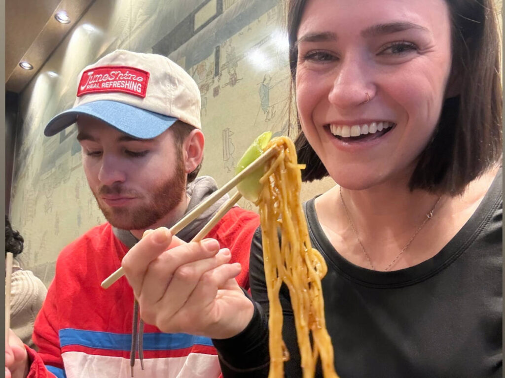 The author, Betty Hurd with her boyfriend eating Tokyo stir-fried noodles