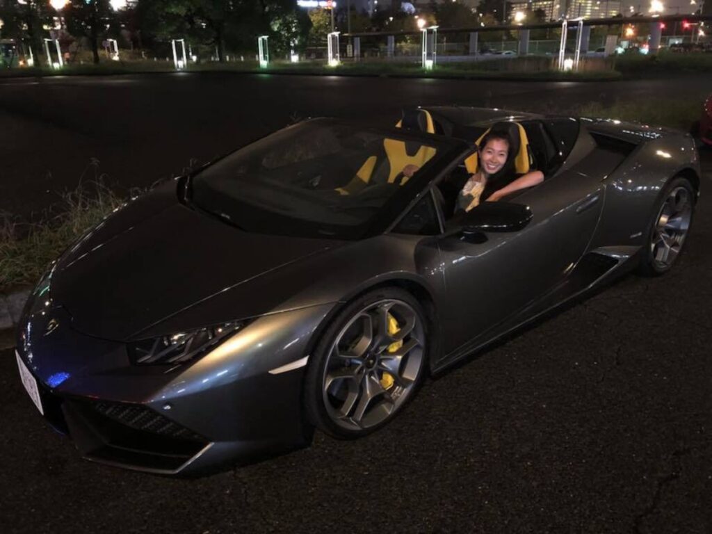 Author Lia riding a supercar in Tokyo