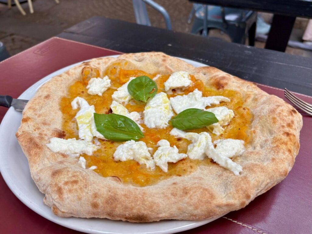 A serving of Yellow tomato and burrata pizza