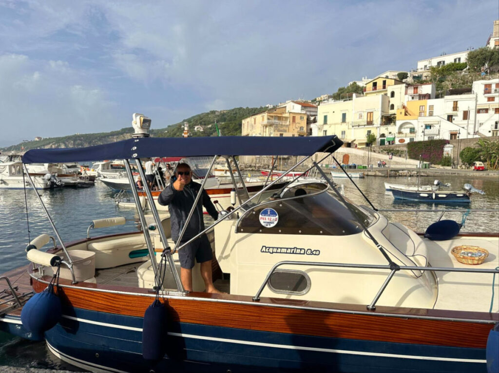 The tour guide on a boat giving a thumbs-up
