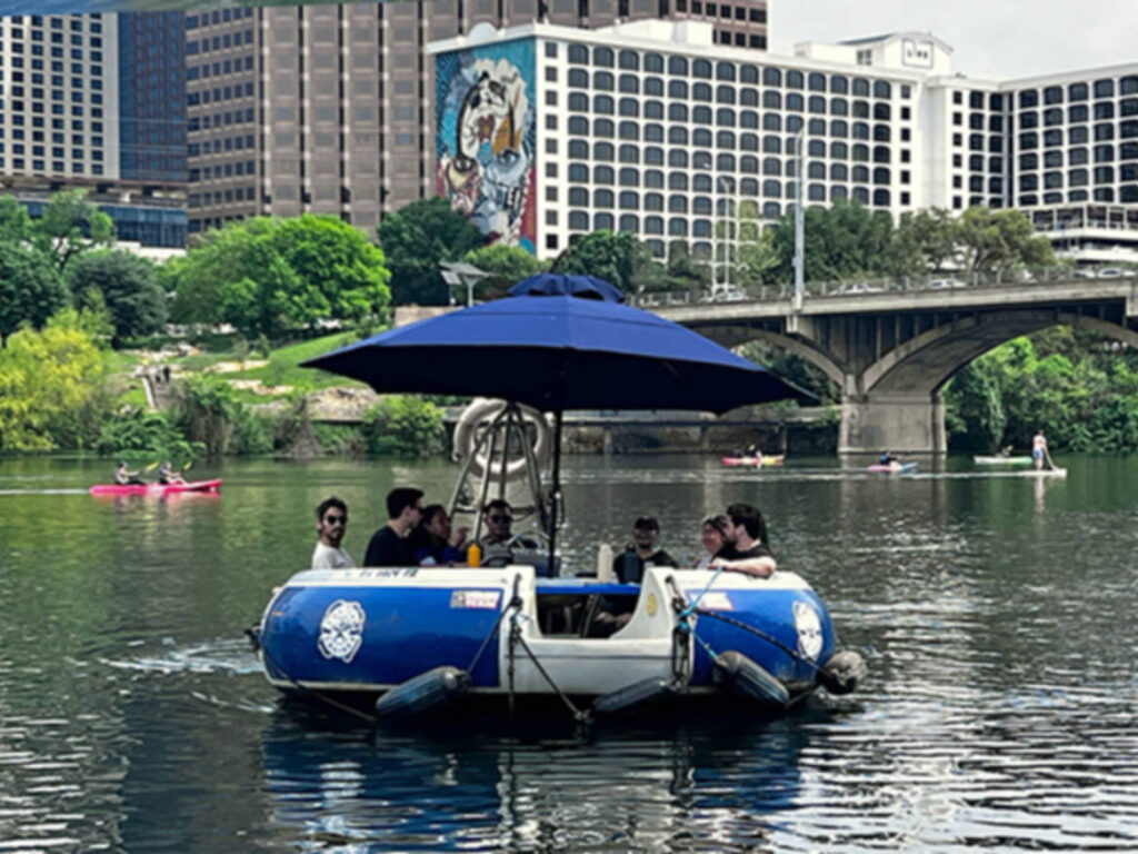 Group of friends touring the Lady Bird Lake on a small boat