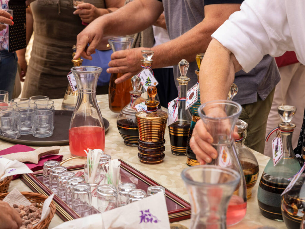 Collection of traditional glass gold painted carafes filled with typical Croatian home made liqueurs
