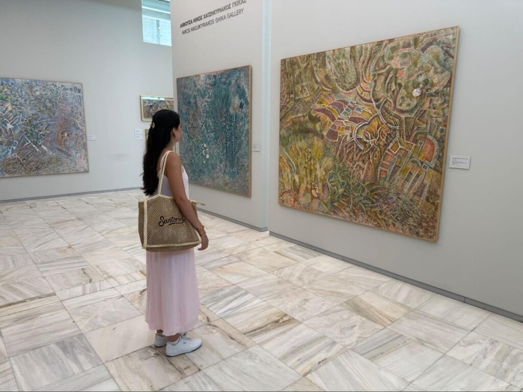 Travel Lemming's Clara looking at an artwork at the National Gallery of Athens