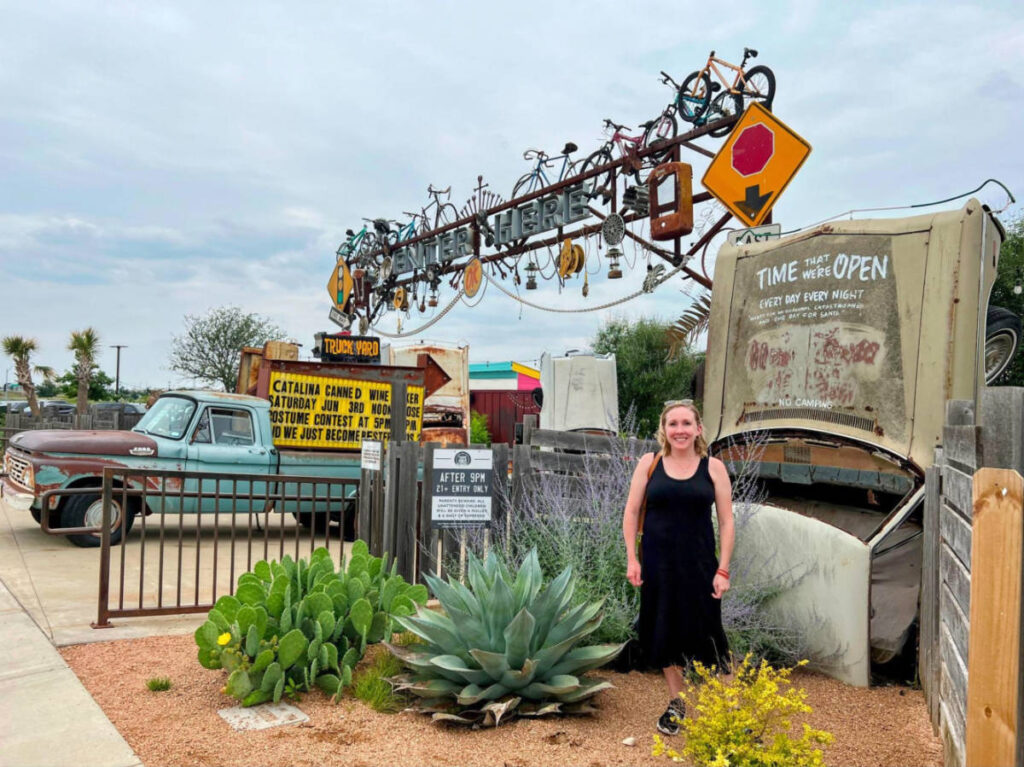 Author Sarah Heath standing in the entrance of Truck Yard located in the Colony