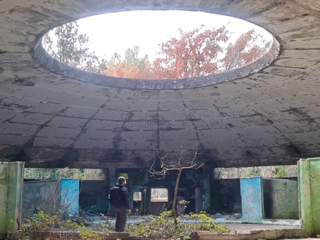 Author Matthew standing inside an abandoned building in Tskaltubo