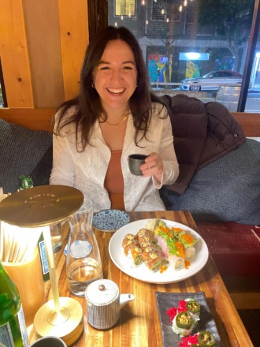 The author, Laura McFarland drinking a sake at Tsunami Panhandle
