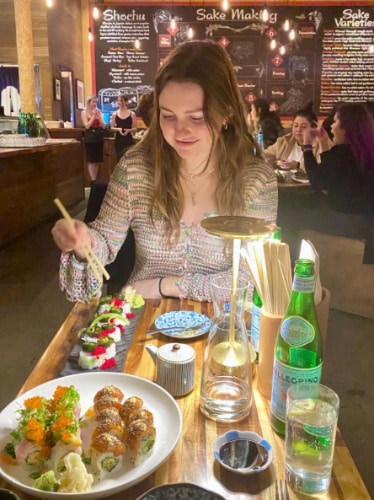 The author's partner enjoying her sushi at Tsunami Panhandle