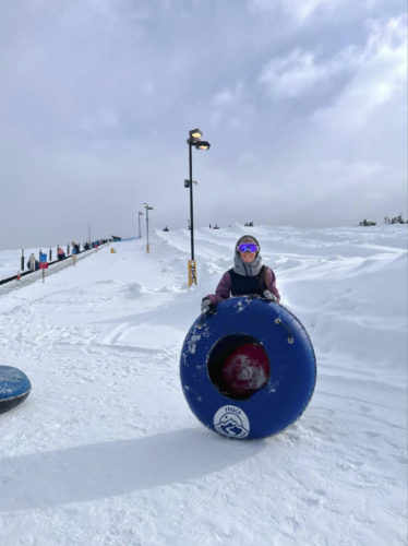 Travel Lemming Editor Abigail Bliss holding her snow tube at Frisco Adventure Park