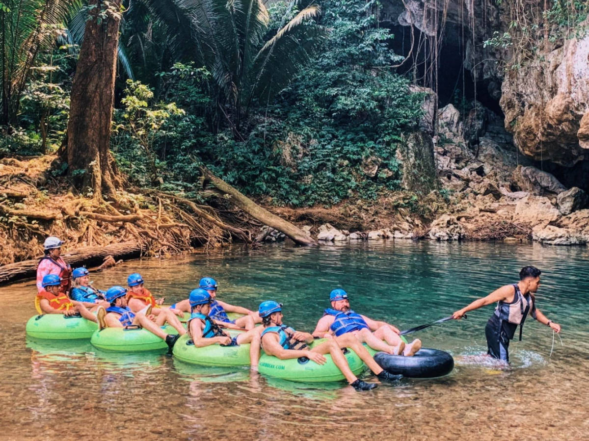 Tourists on a Tubing tour through Mayan caves