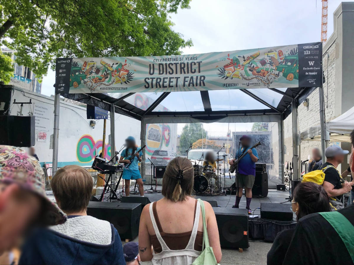 People watching a live performance at the U-District Street Fair