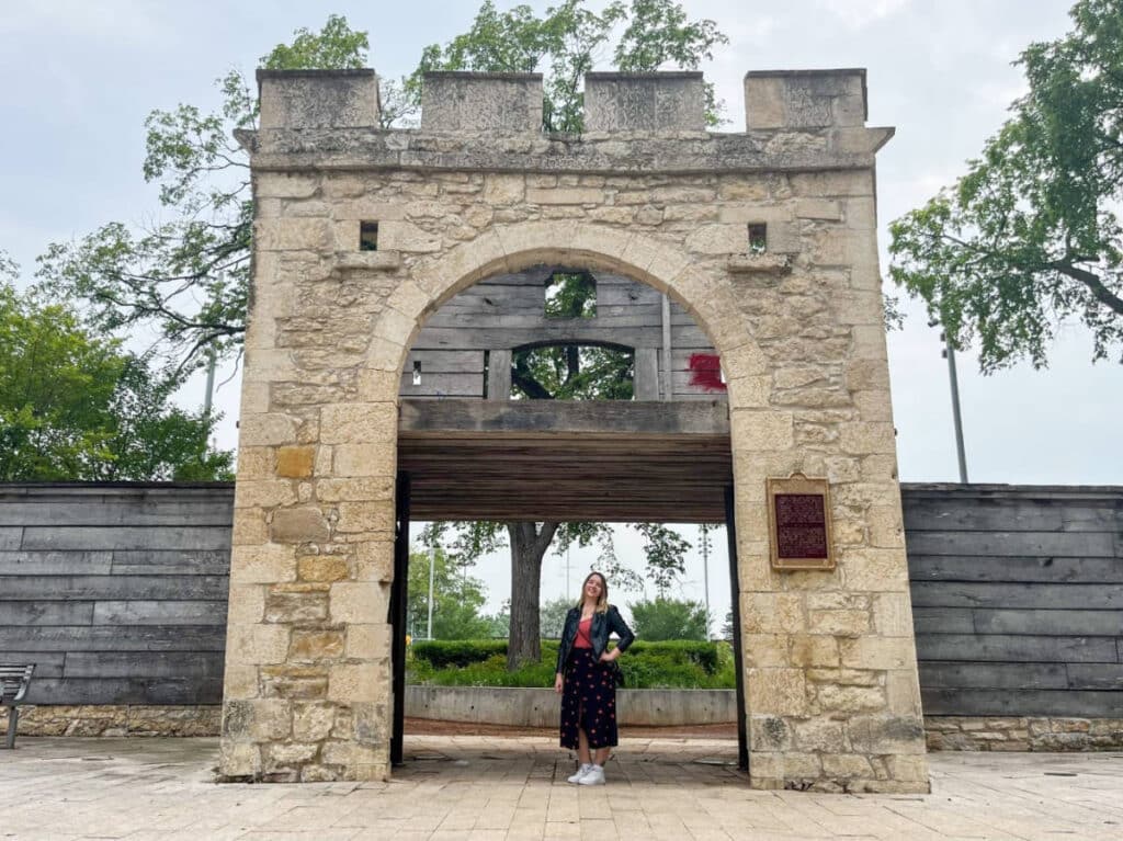The author, Taylor Herperger smiling for a photo at the Upper Fort Garry Historic Site