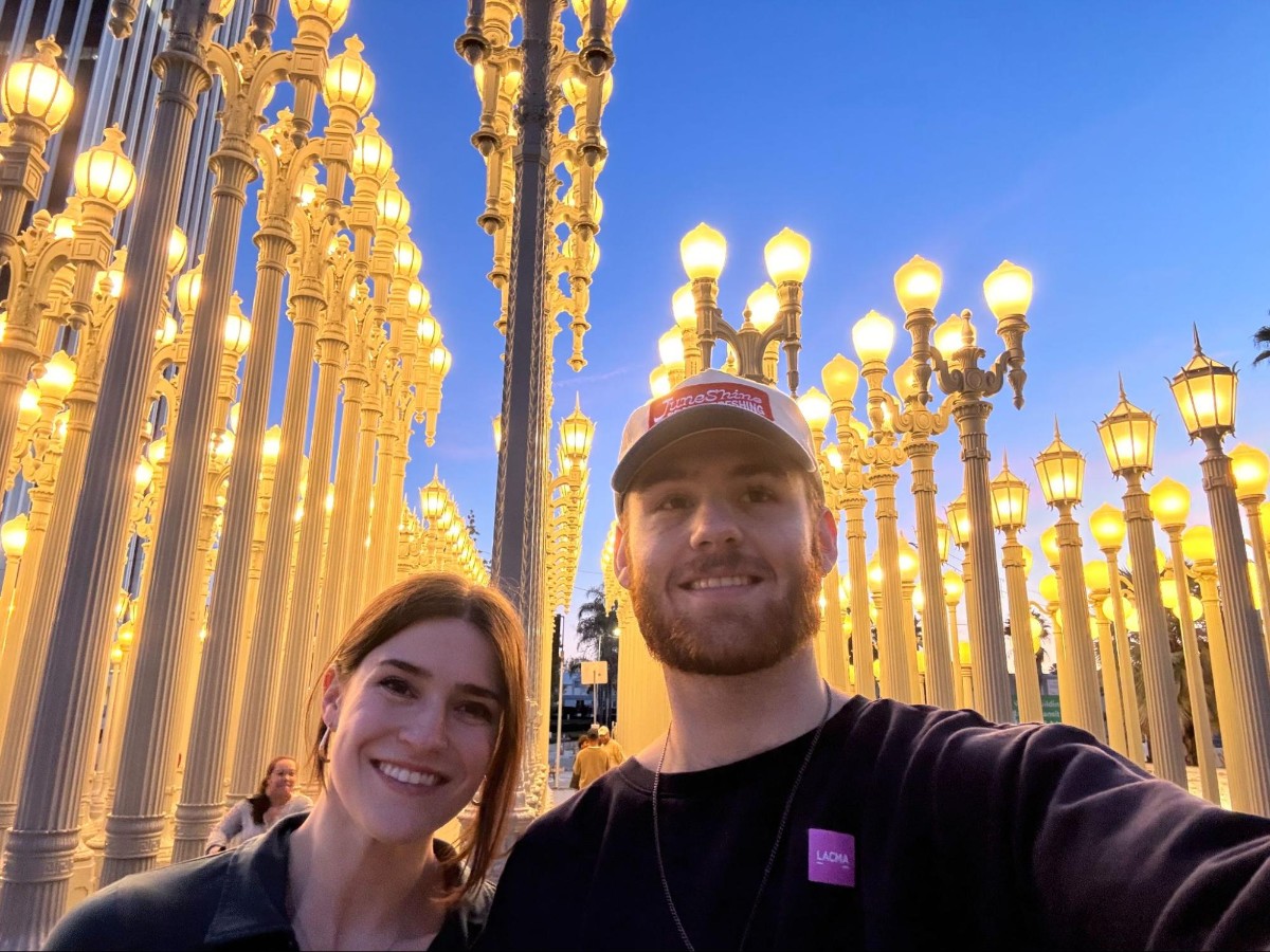 Author Betty and Michael taking a selfie at the Urban Light installation at LACMA