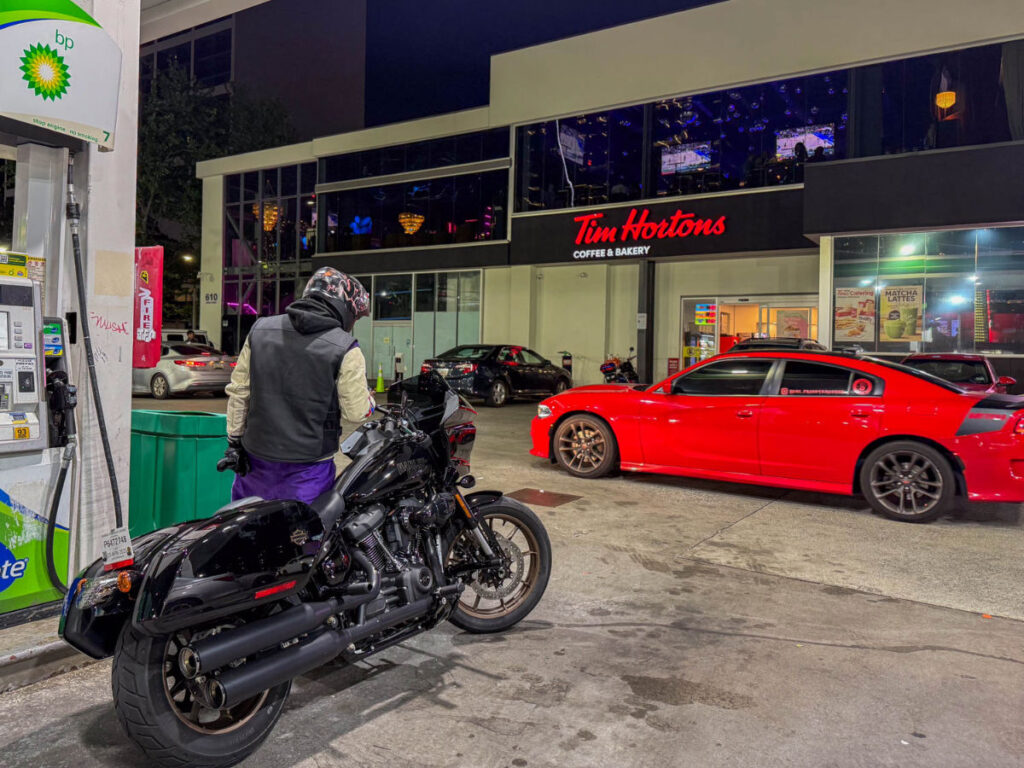 A motorcyclist gases up near the V12 Restaurant