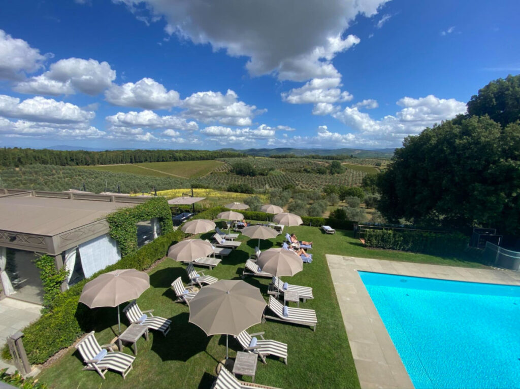 View of the swimming pool, umbrellas and pool chairs in Tuscany