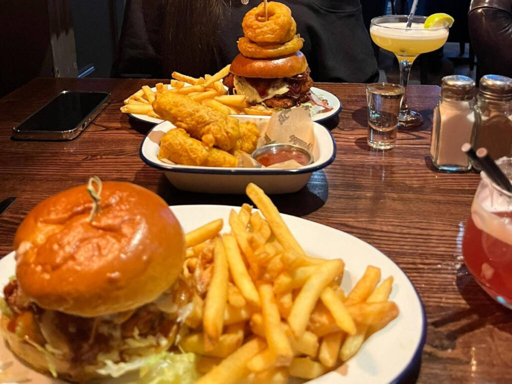 View of the stacked burgers with cocktails at the Van Winkle