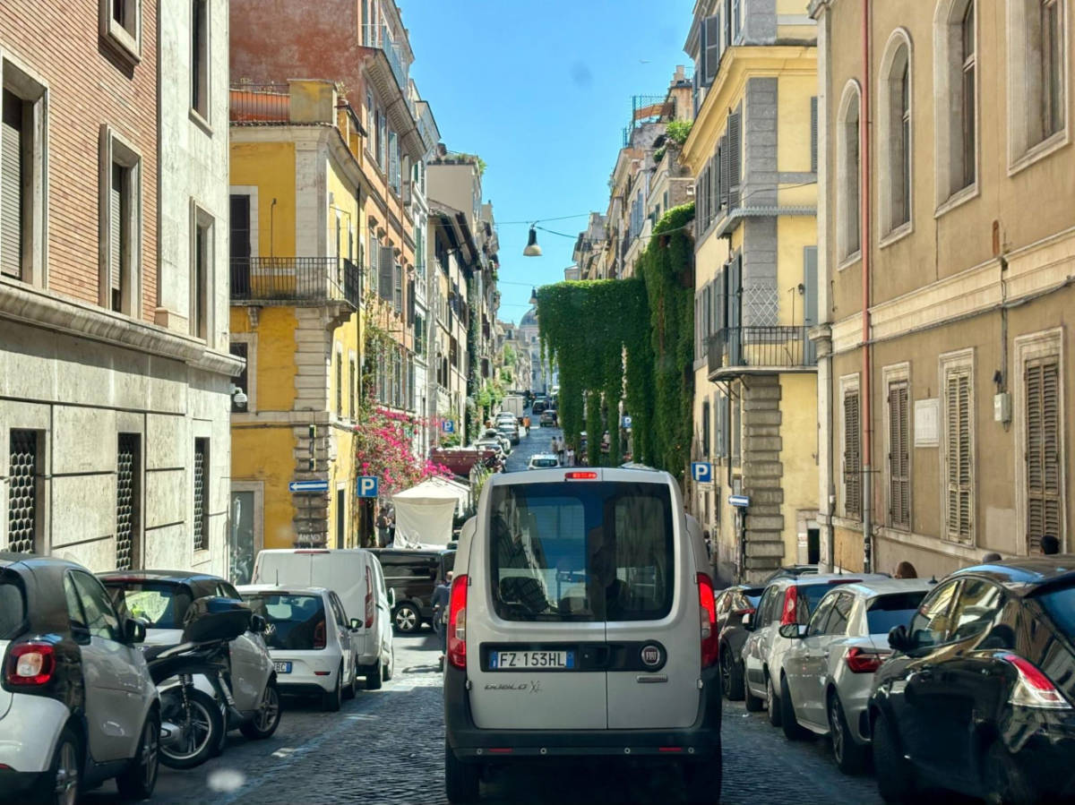 A van driving along a crowded street in Rome