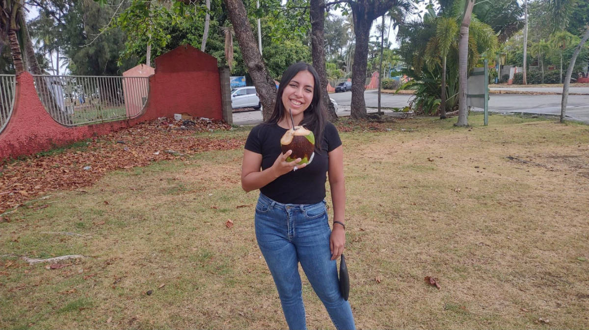 The author, Vanessa Ramos holding a coconut drink